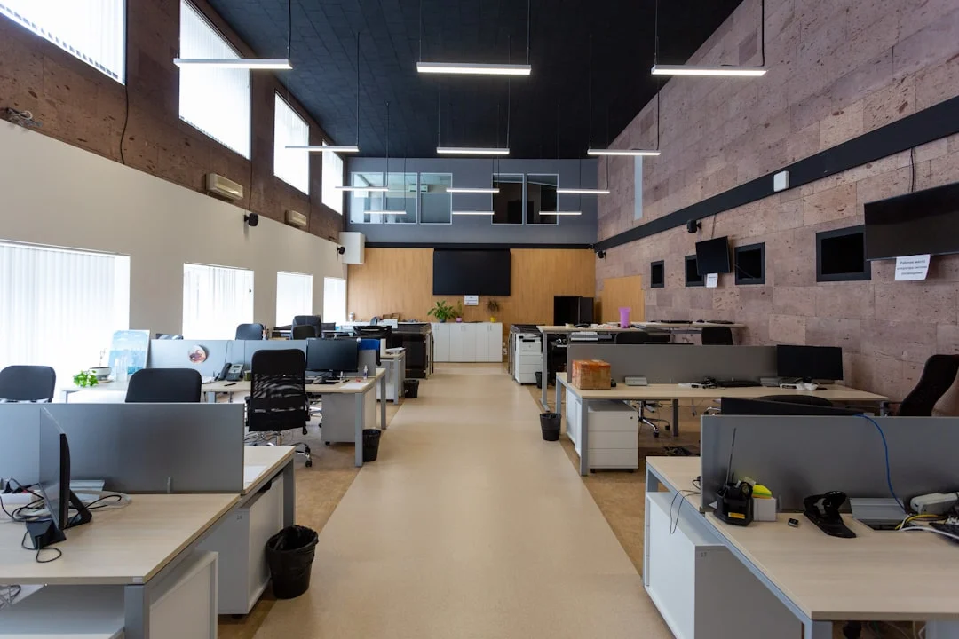 Clean open plan office with rows of desks and computers